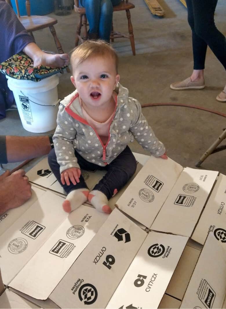 Bottling 2017 Vintage - a smiling baby on the boxes of wine bottles.