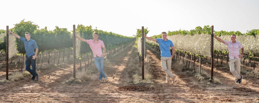 Oswald Vineyard men at end of vine rows